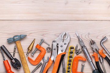 Set of various home tools lying in  row on  light wooden background. Men's style. Studio shot. Copy space.
