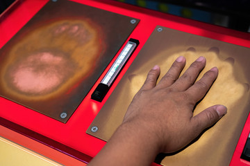 Hand touching copper sheet and brass for compare heat, warm and conduction, convection, conduction radiation temperature in science classroom.