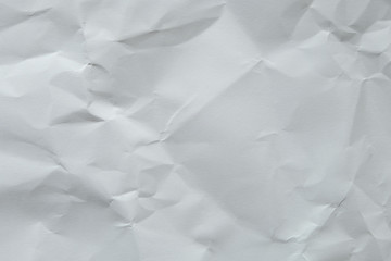 Wrinkled white blank plain paper with shade of light and shadow. Ideal for background or wall wallpaper with copy space for text.