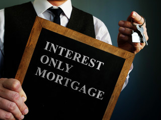 Board with words interest only mortgage and key.