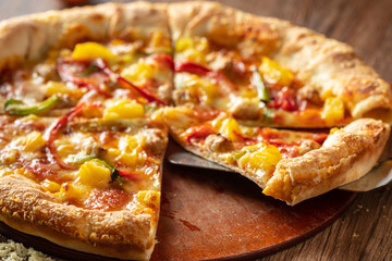 whole italian pizza on wood table with ingredients