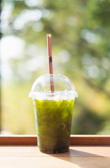 Fresh and cold ice green tea on table