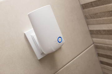 Wifi home repeater plugged in closeup.