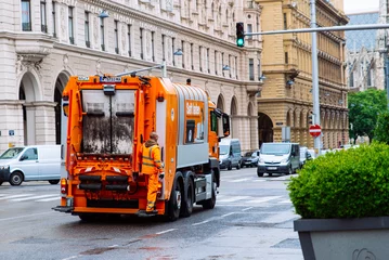 Fotobehang view if trash garbage truck at vienna street © phpetrunina14
