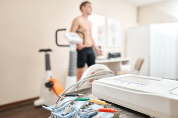 Clothespins of the ECG machine in the foreground. Athlete does a cardiac stress test and VO2 in a...