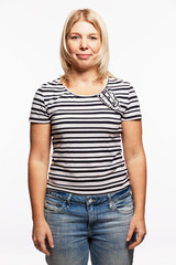 Obraz premium Young blond woman in jeans. White background. Vertical.