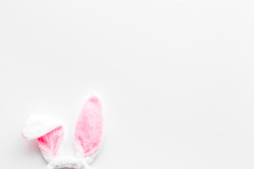 Easter bunny's ears on white background top-down copy space