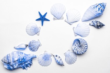 Summer holiday poster with aquamarine light blue sea shells and starfish on white background, copy space. Top view travel or vacation concept. Flat lay