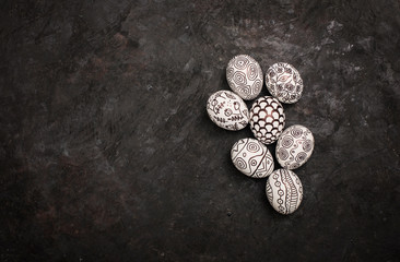 Creative trendy painted marker easter eggs on black background. Easter ideas.Copy space for text. Minimalism. Background with easter eggs.