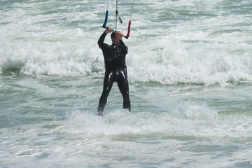 man kiteboarding or kitesurfing