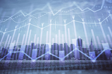 Forex graph on city view with skyscrapers background multi exposure. Financial analysis concept.