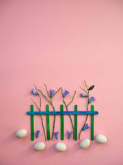 easter time spring landscape with easter eggs, hyacinth flowers, trees, wood fence on pastel colors background