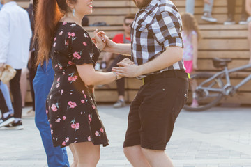 Kizomba, bachata or salsa concept - beauty couple dancing social dance on open air party.
