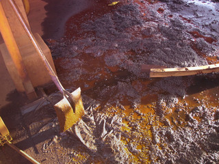 Isolated old shovel covered contaminated with grease at construction work site Perth, Australia