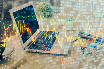 Financial graph colorful drawing and table with computer on background. Multi exposure. Concept of international markets.