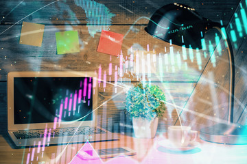 Double exposure of graph and financial info and work space with computer background. Concept of...