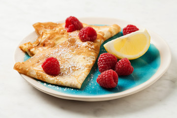 Folded pancakes on white marble background
