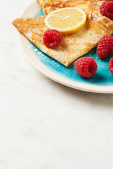 Folded pancakes on white marble background