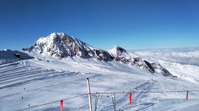 Austria - Kaprun. View from the top of the mountain Kitzsteinhorn. Ski bugel. Blue cloudless sky