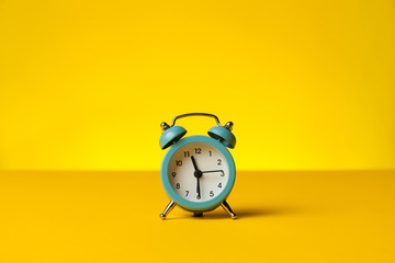 Working hours and overtime work. Hurry work, concept. Clock on yellow background.