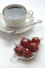 jam in a bowl, a cup on a saucer and a spoon. on white background.
