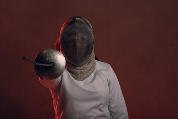 Fencer woman with fencing sword.