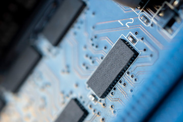Close up macro shooting computer circuit mainboard integrated elements. Shallow depth of field. Science and technology concept.