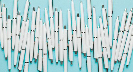 White pens on a blue background as a symbol of creative Brainstorming of a successful Business Strategy.