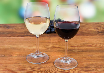 Two glasses of red and white wine on rustic table