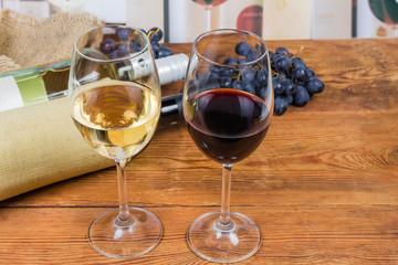 Two glasses of red and white wine on rustic table