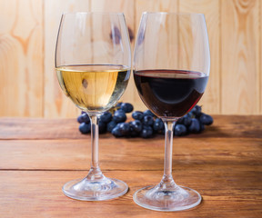 Two glasses of red and white wine on rustic table