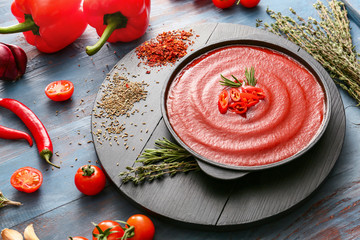 Pan with tomato sauce on table
