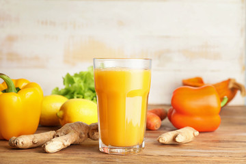 Glass of fresh vegetable juice on table