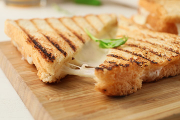 Tasty sandwich with cheese on wooden board, closeup