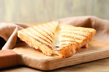 Tasty sandwich with cheese on wooden board, closeup