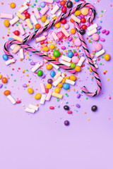 Assortment of tasty candies on color background