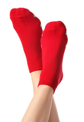 Legs of young woman in socks on white background