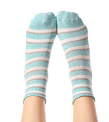 Legs of young woman in socks on white background