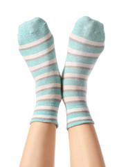 Legs of young woman in socks on white background