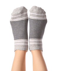 Legs of young woman in socks on white background
