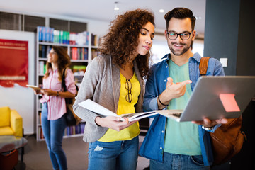 Group of college students studying in the school library