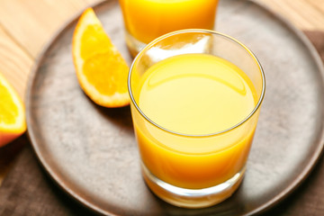 Glasses of fresh orange juice on table