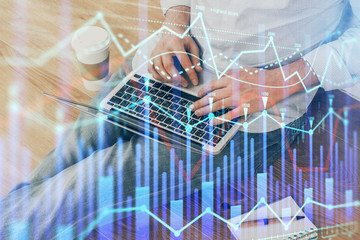 Forex graph with businessman working on computer in office on background. Concept of analysis....