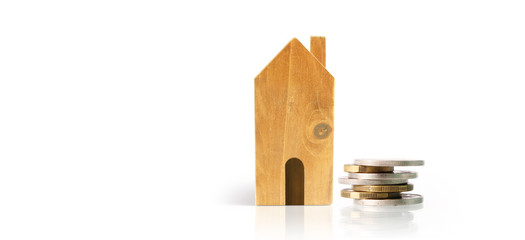 Small houses standing on stacks of coins. investment saving concept