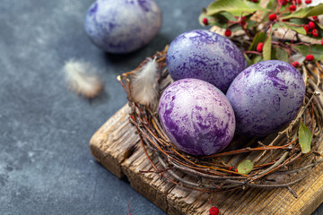 Blue and purple Easter eggs in the nest.