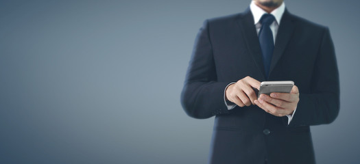 Man hand holding smartphone device and touching screen