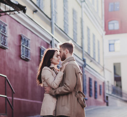 romantic young couple stands in an embrace in the city