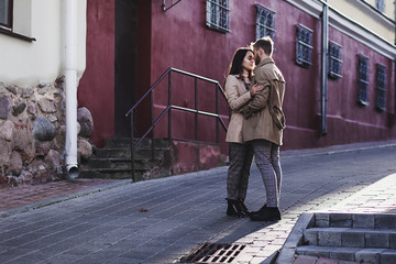 beautiful couple in love embraces at sunset in an urban setting