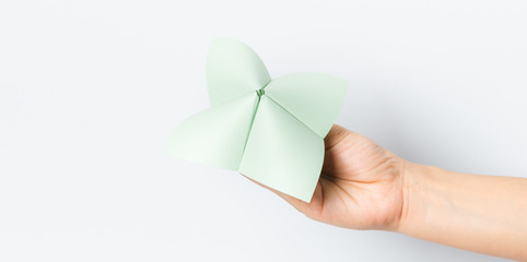 Hand in a paper fortune teller isolated on white background.