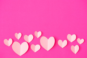 Fototapeta na wymiar Shape of heart flying on pink paper background.